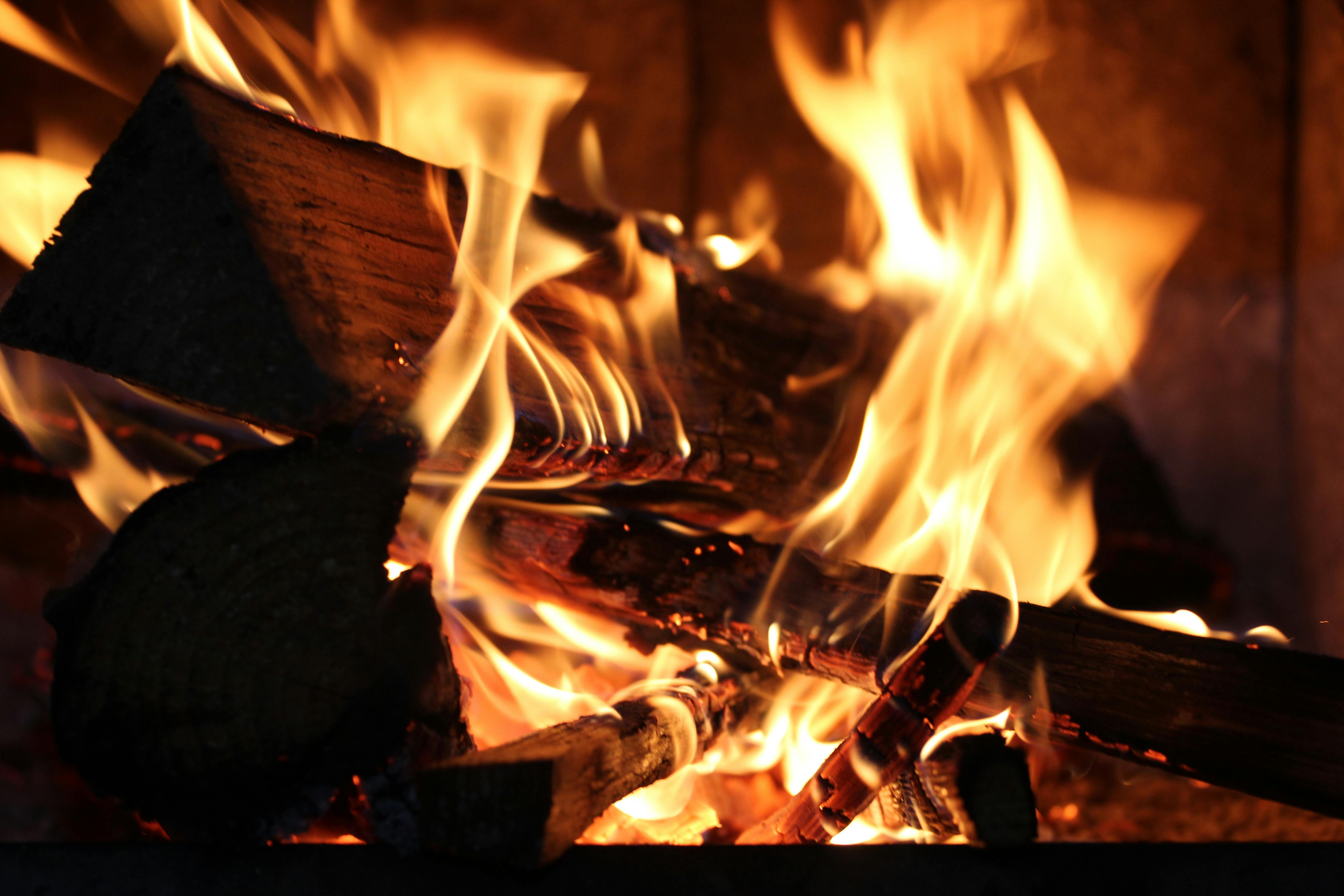 Logs burning down to embers in an open fireplace